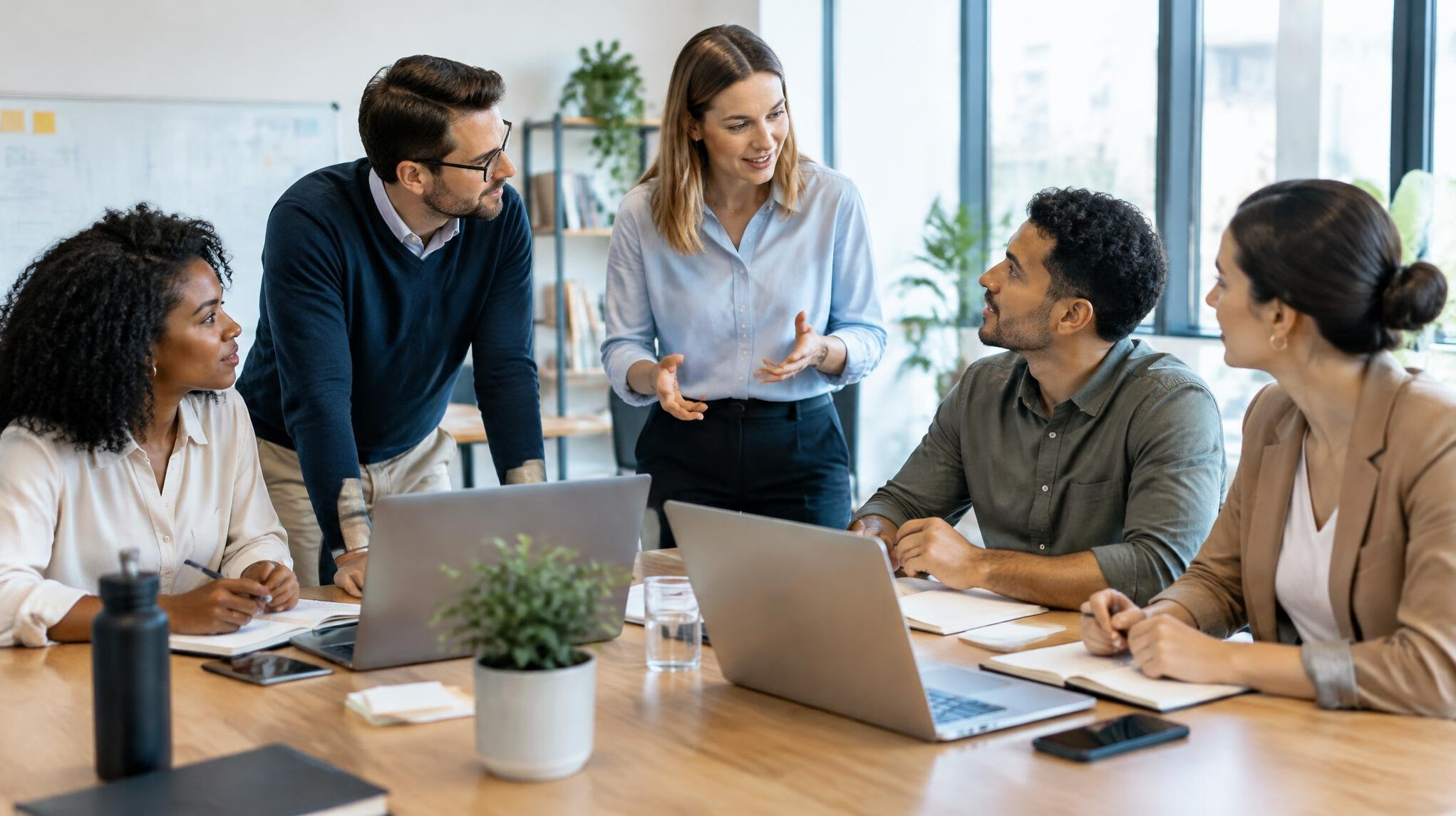 Diverse team of professionals discussing strategy around a table
